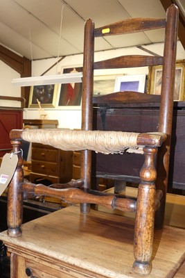 Lot 1225 - A child's elm and rush seat ladderback single...