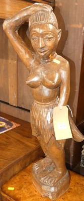 Lot 1233 - A tribal stained and carved hardwood standing...