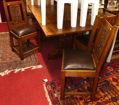 Lot 1253 - A 1930s oak dining suite, comprising; a...