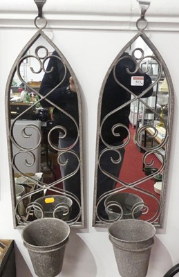 Lot 513 - A pair of arched metal framed garden mirrors,...