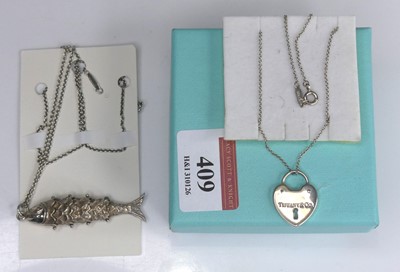 Lot 409 - A Tiffany & Co silver heart shaped locket, on...