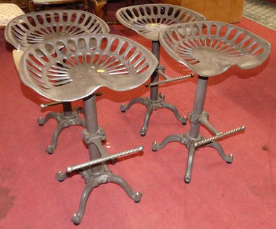 Lot 1293 - A set of four contemporary cast iron swivel...