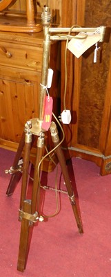 Lot 1301 - A mahogany and brass converted tripod lamp...