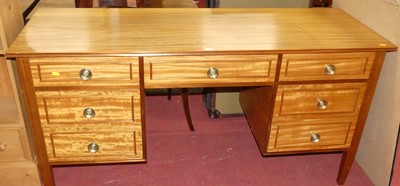 Lot 1315 - A 1970s teak kneehole writing table fitted...
