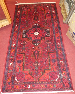 Lot 1331 - A Persian woollen red ground Hamedan rug, with...
