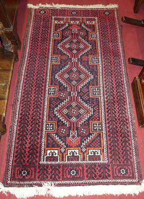 Lot 1332 - A Persian woollen red ground hall runner, with...