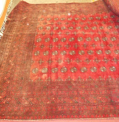 Lot 1344 - A Persian woollen red ground Bokhara rug,...