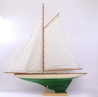 Lot 57 - A carved wooden hull pond yacht, with canvas...